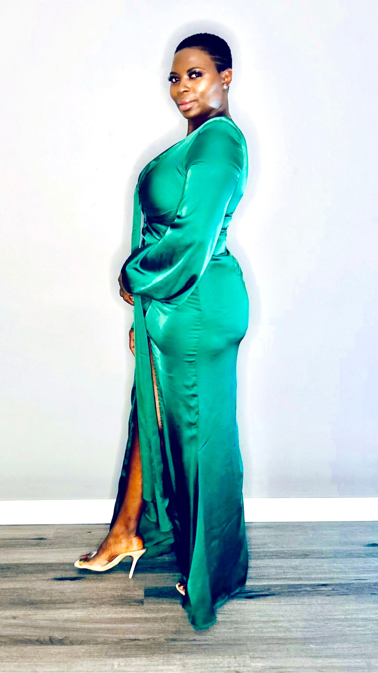 Side profile of the Green satin dress showing its smooth, flowy fabric and elegant fit.
