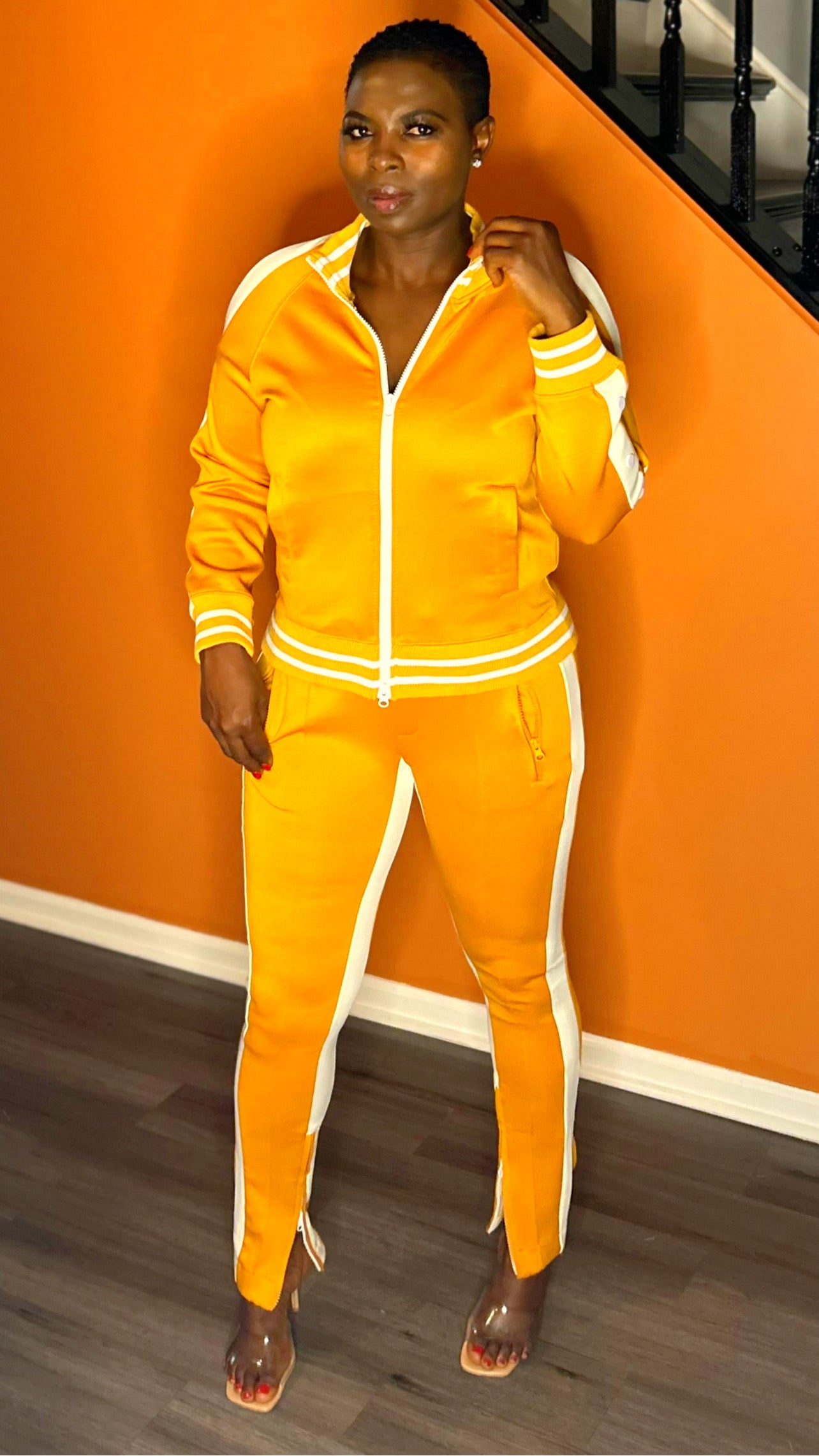 Close-up of the cold-shoulder top on the mustard tracksuit for a modern look