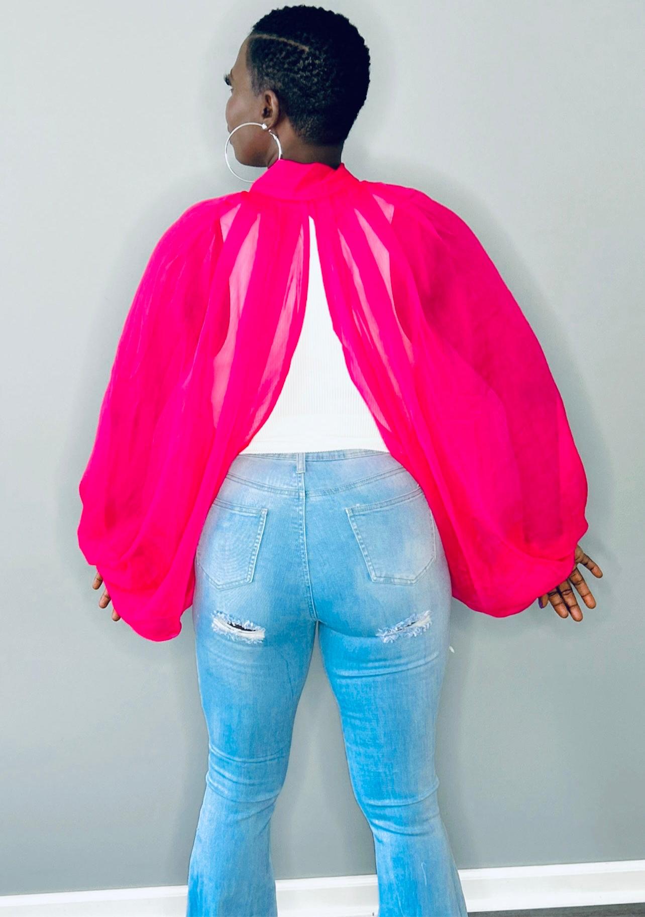 Back view of the pink blouse showcasing the dramatic balloon sleeve and lightweight fabric