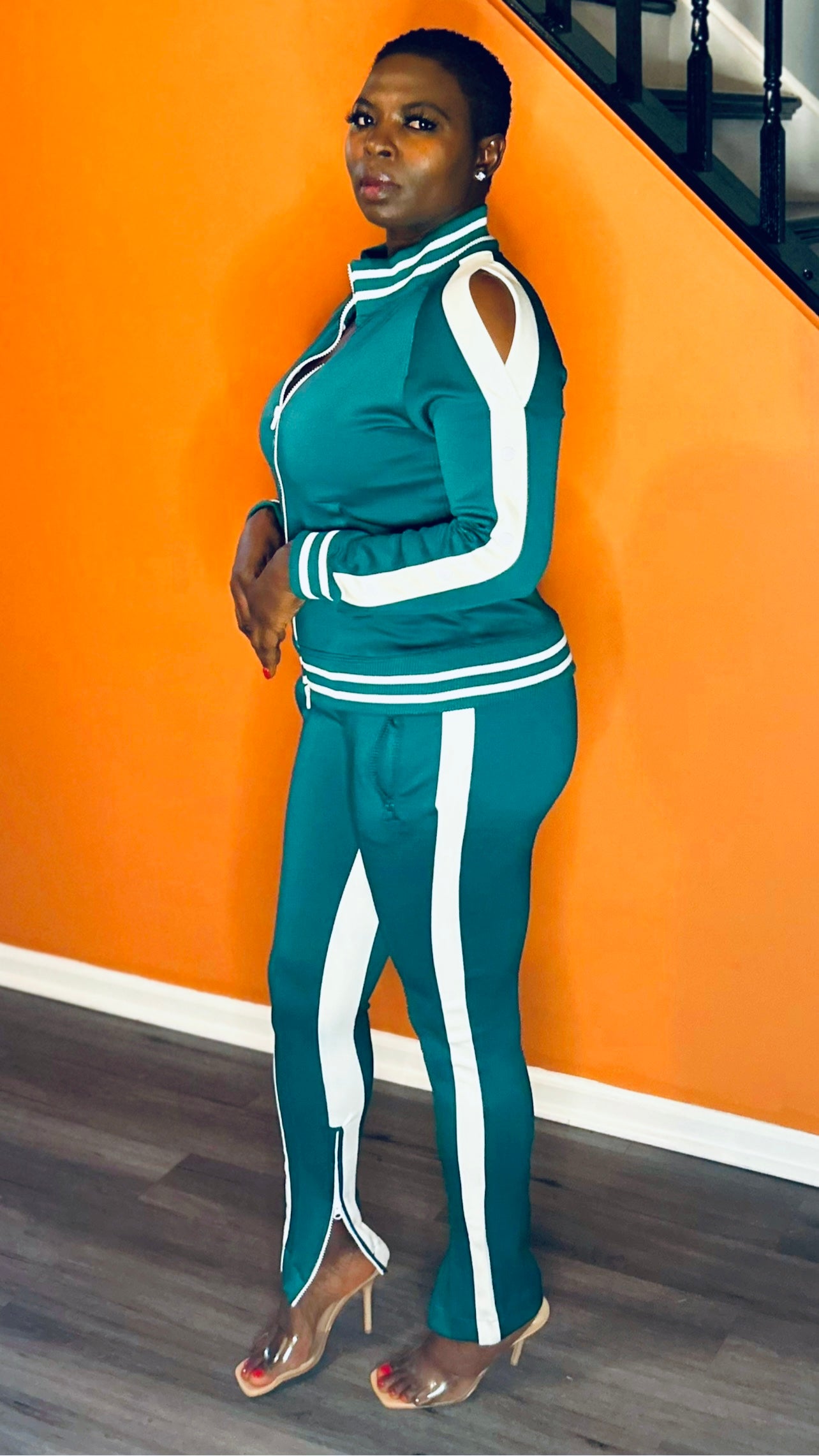 Side profile of the 2-piece green women's tracksuit showcasing the chic, relaxed fit.