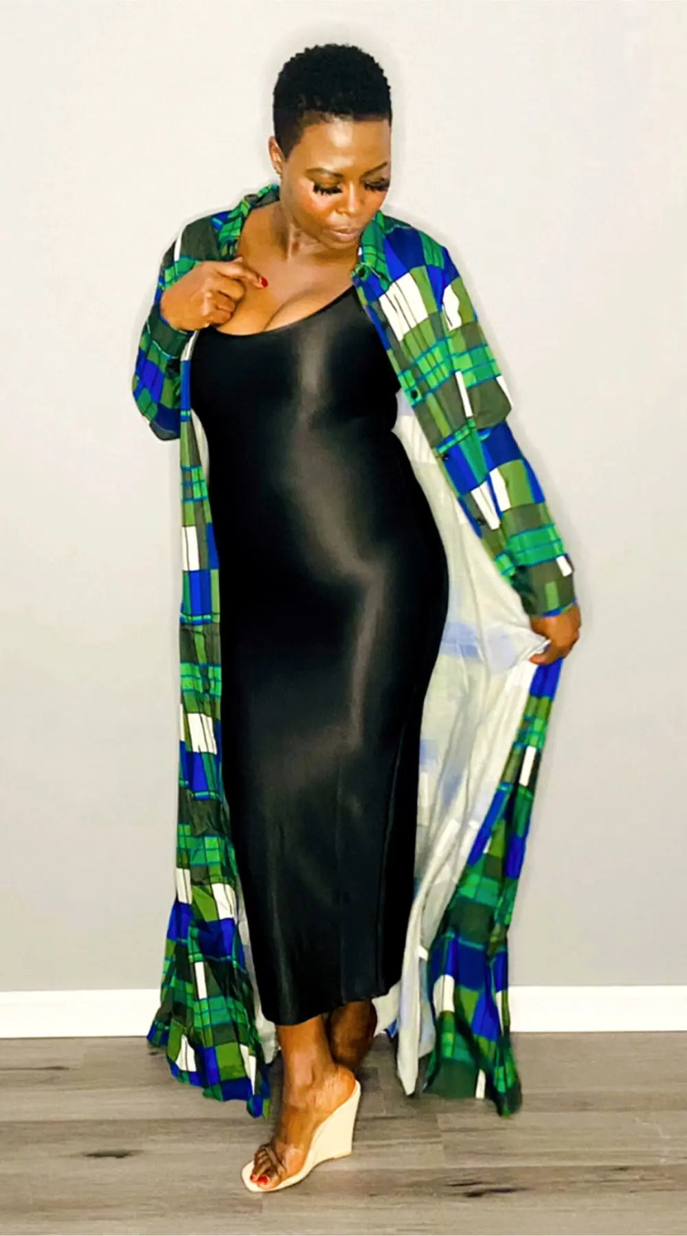 Side profile of the green maxi shirt dress showcasing its flowy fit and button-down front