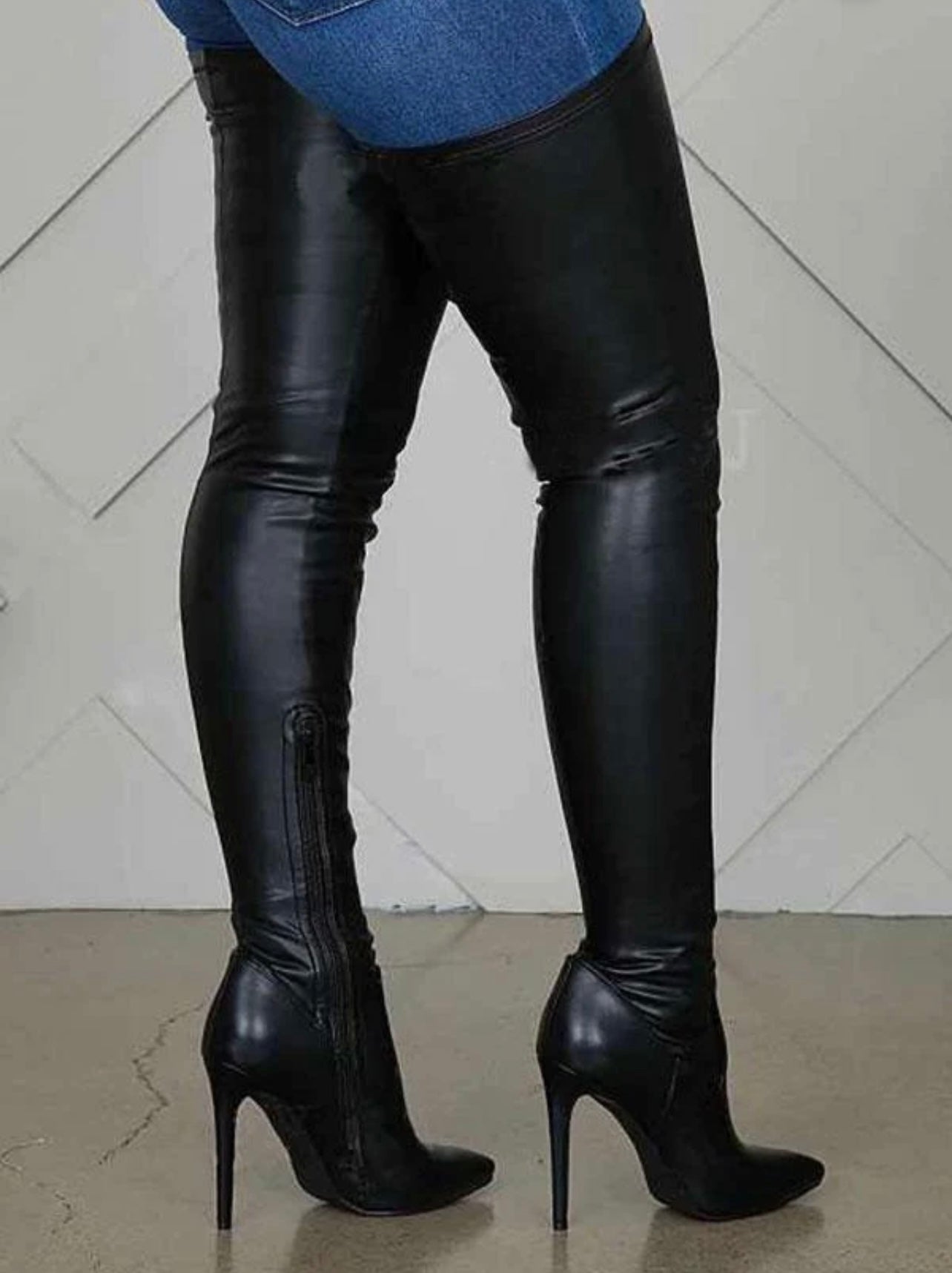Side profile of flat black over the knee boots, perfect for casual and chic outfits.