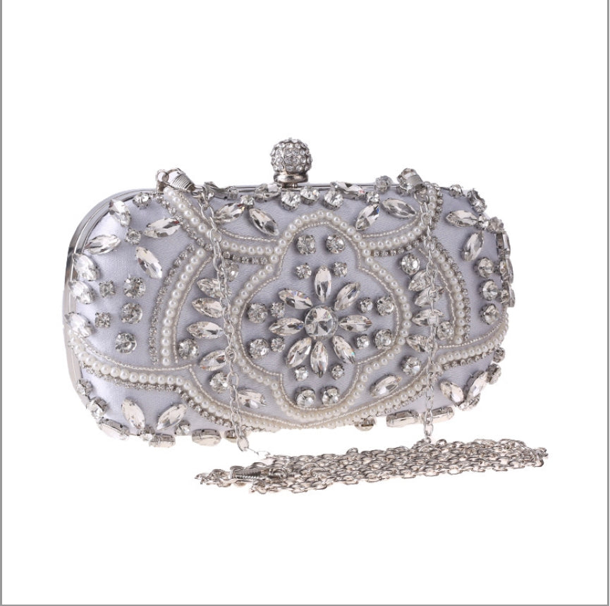Silver evening bag with floral rhinestone embellishments, perfect for formal occasions