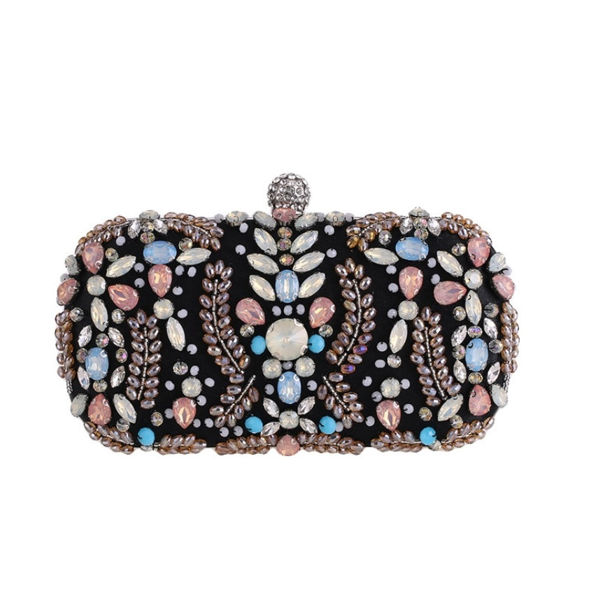Close-up of the intricate floral rhinestones on the black luxury clutch.
