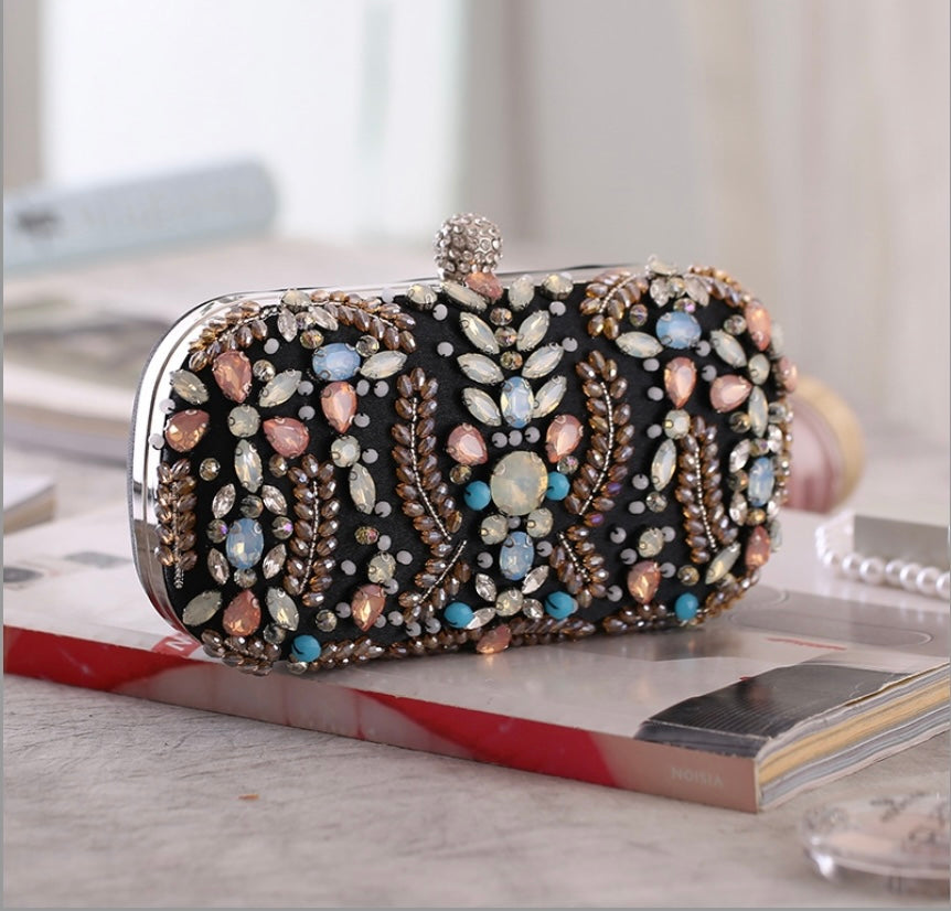 Side profile of the black evening bag showcasing its sleek and elegant design