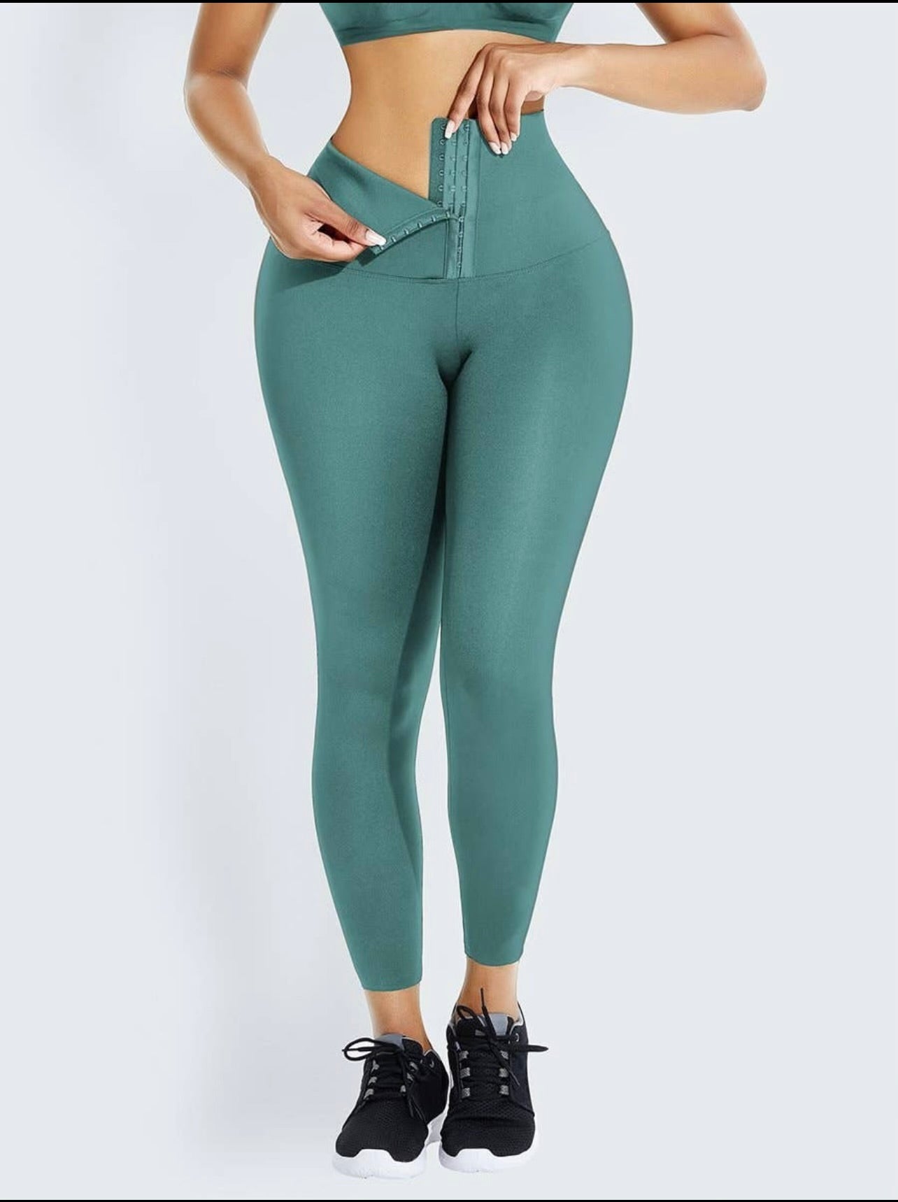 Model wearing high waist shapewear leggings in green color with a sleek and supportive fit.