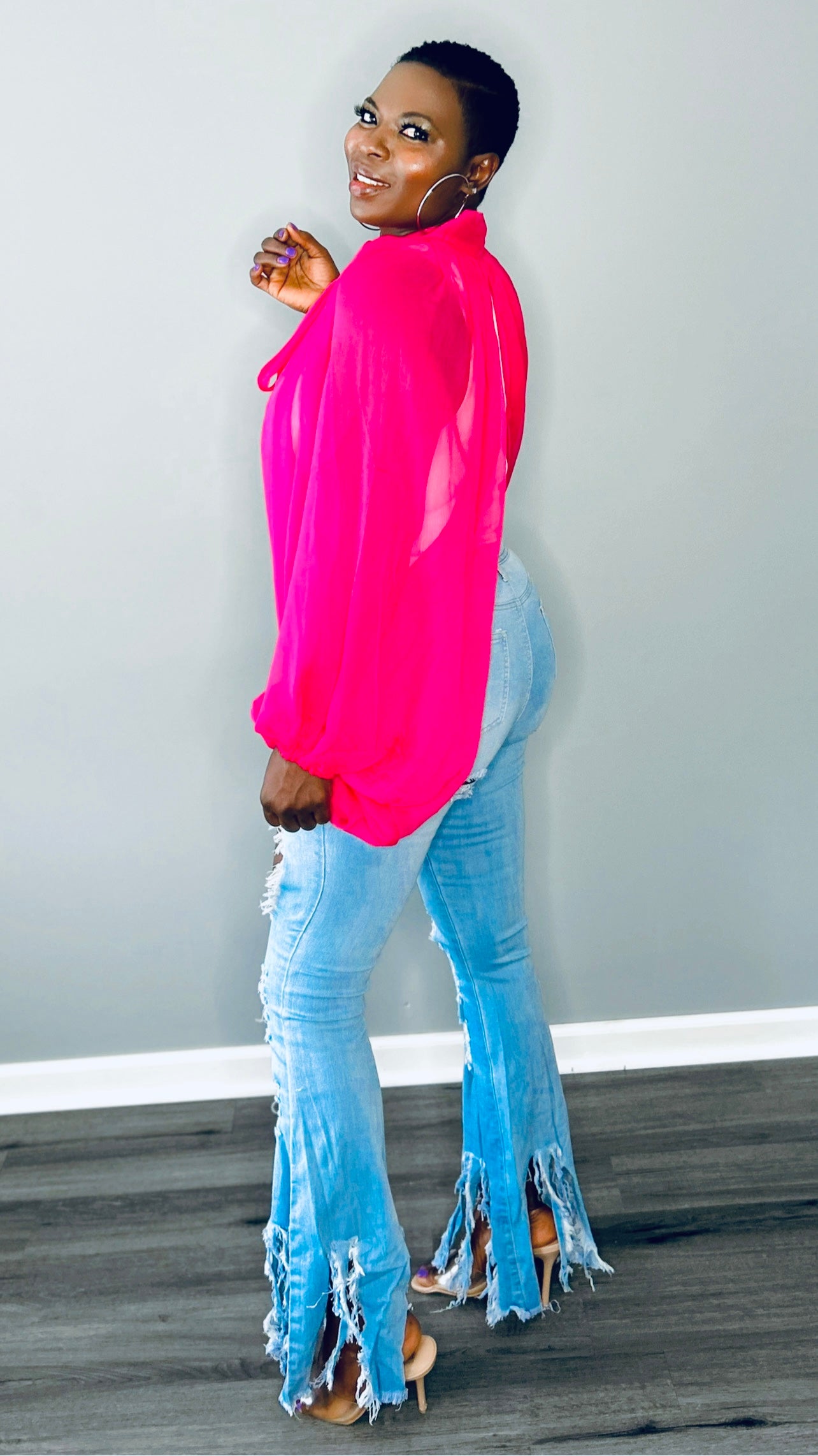 Side profile of the pink blouse showcasing the dramatic balloon sleeve and lightweight fabric
