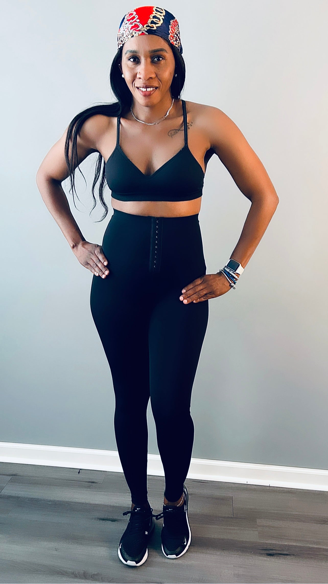 Model wearing waist trainer leggings with a built-in corset design for tummy control.