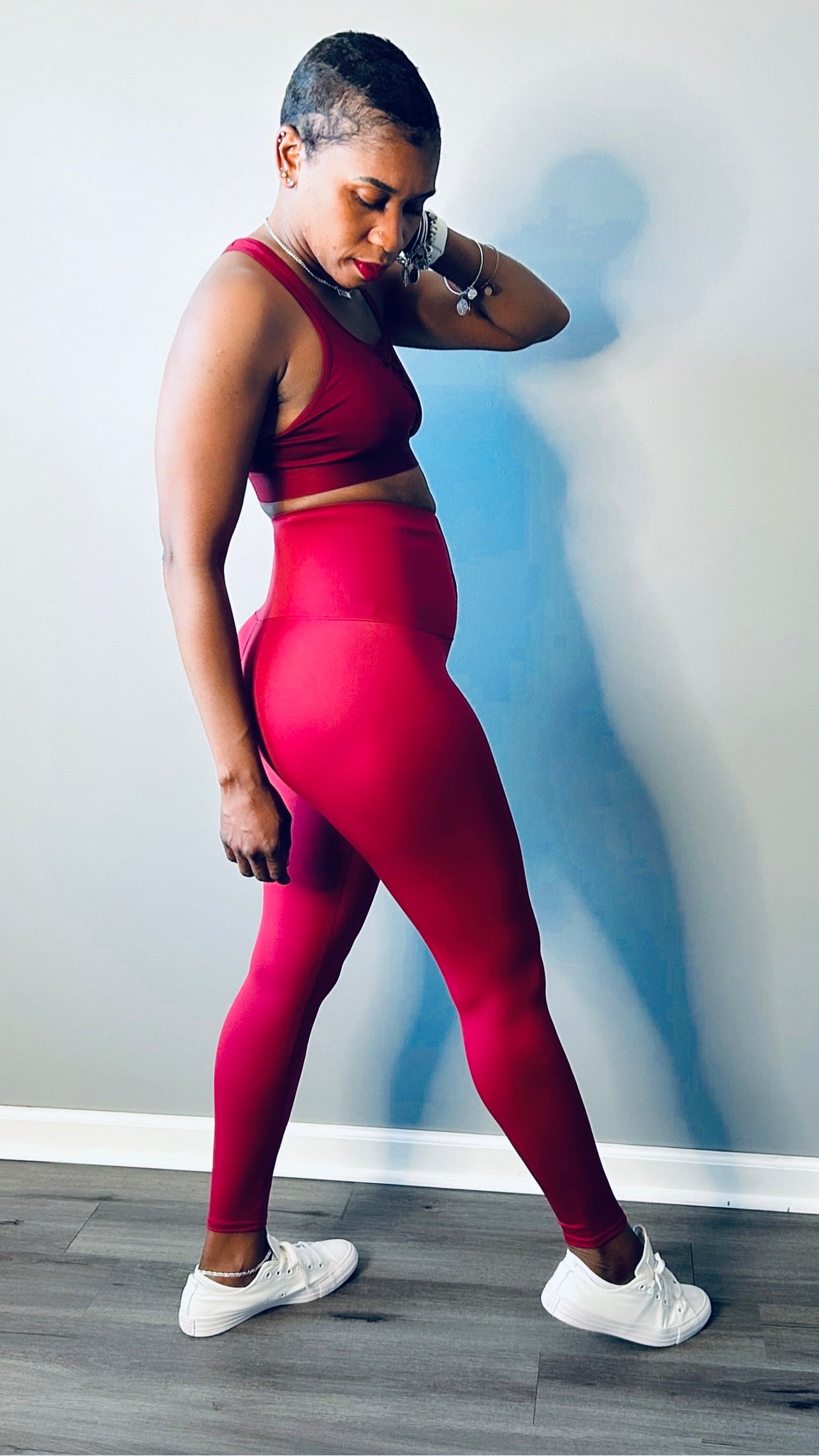 Side profile of the high waist shapewear pants in red color showing tummy control and full-length coverage
