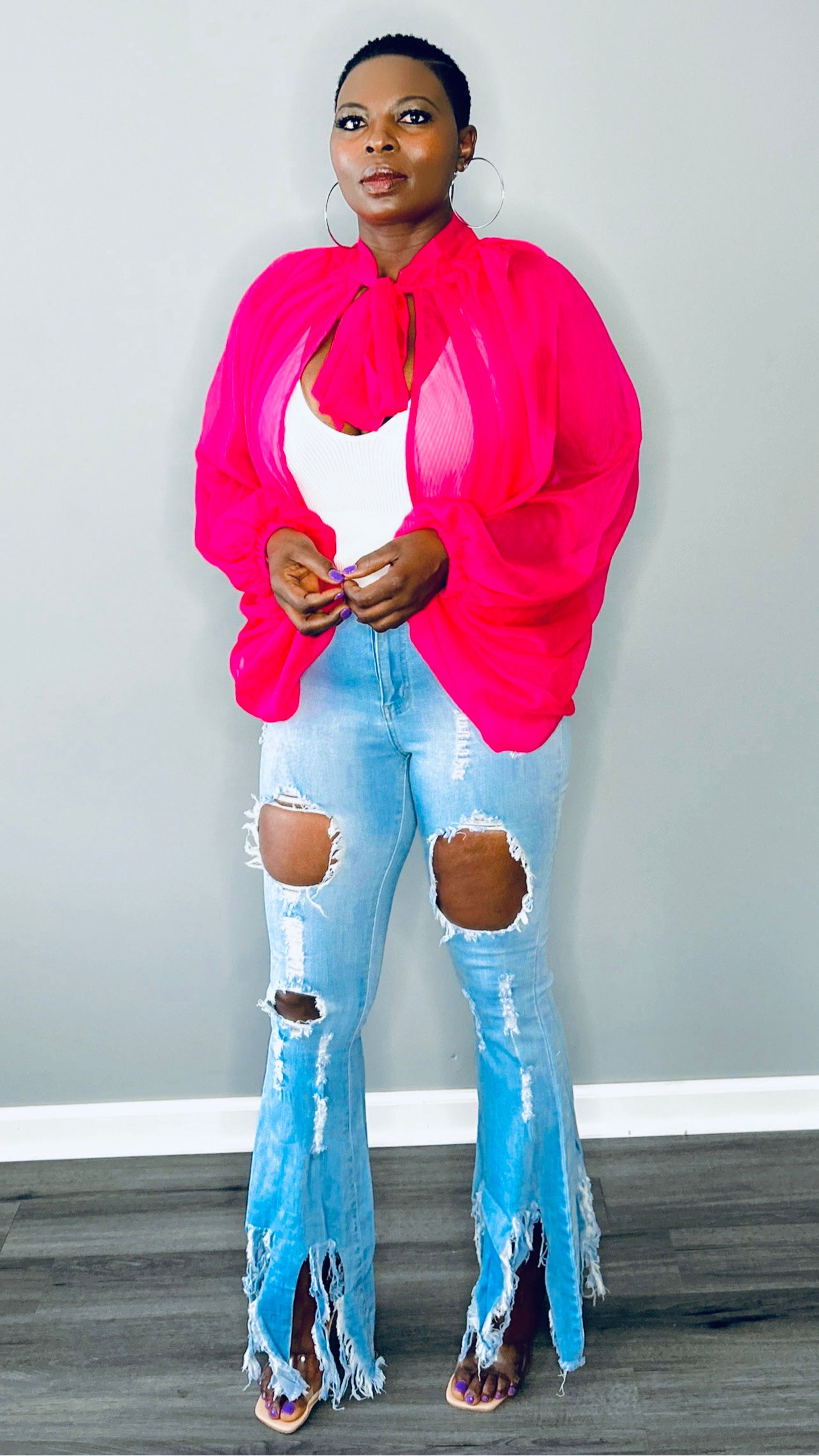 Sheer pink organza blouse with flowy balloon sleeves, perfect for a classy statement.